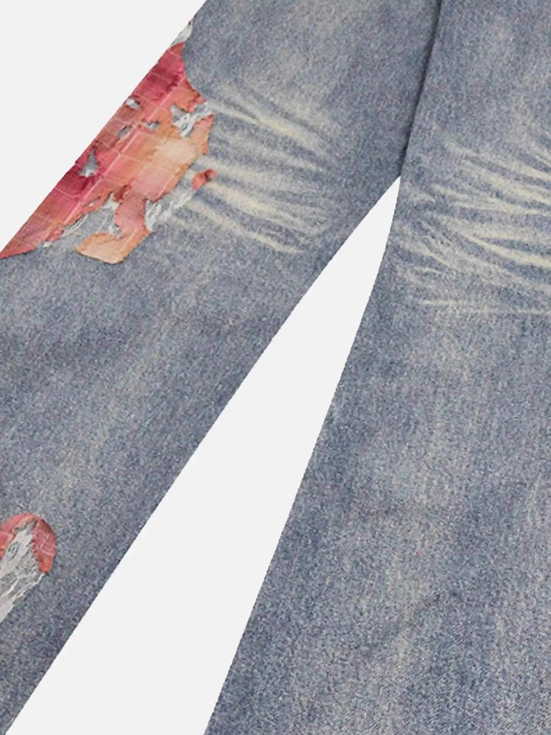 Zoomed-in texture of TALISHKO retro patchwork jeans, highlighting distressed fabric details.