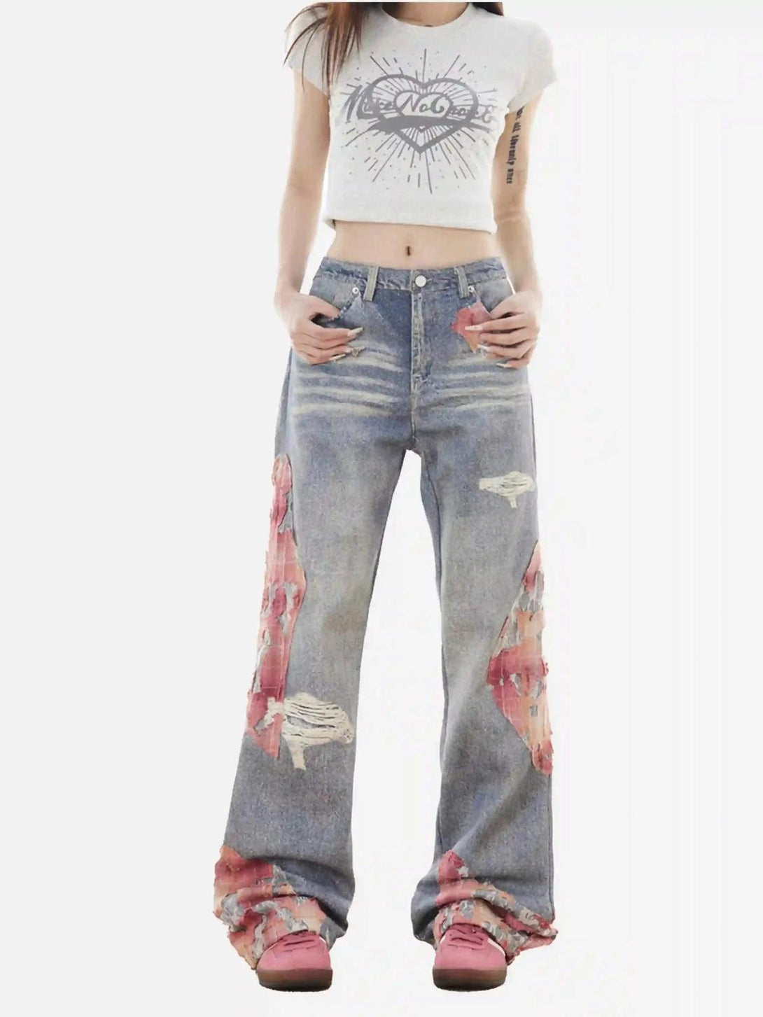 Model wearing TALISHKO retro patchwork street jeans, highlighting unique distressed patterns.