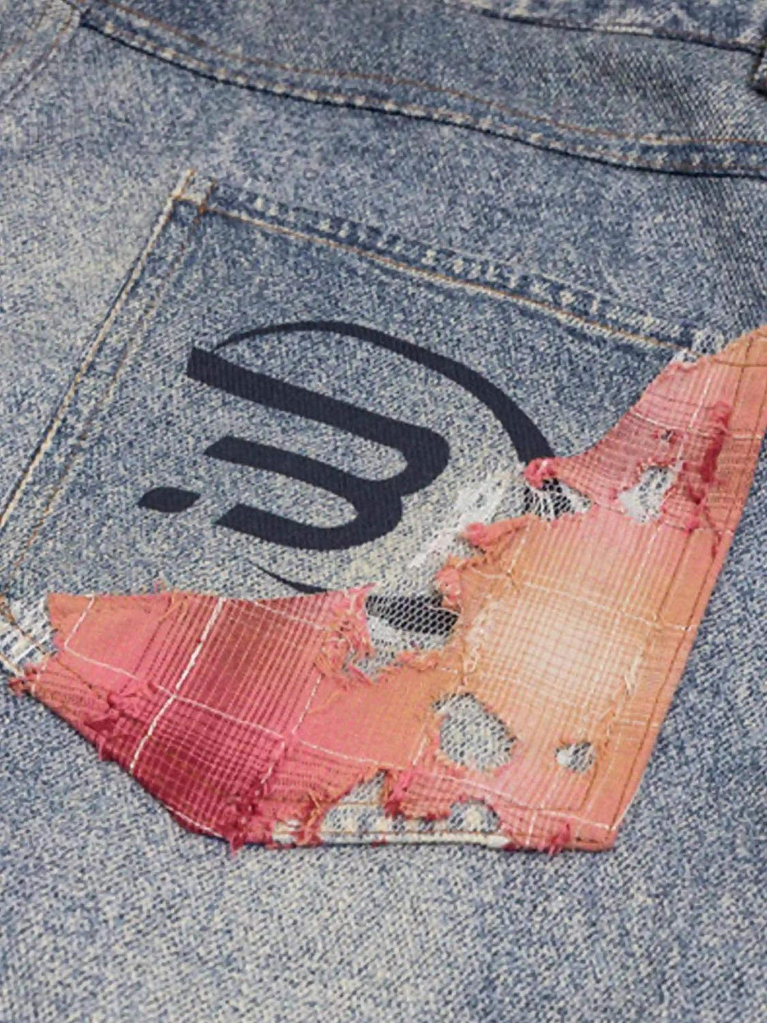 TALISHKO retro patchwork street jeans with a close-up on the distressed back pocket design.