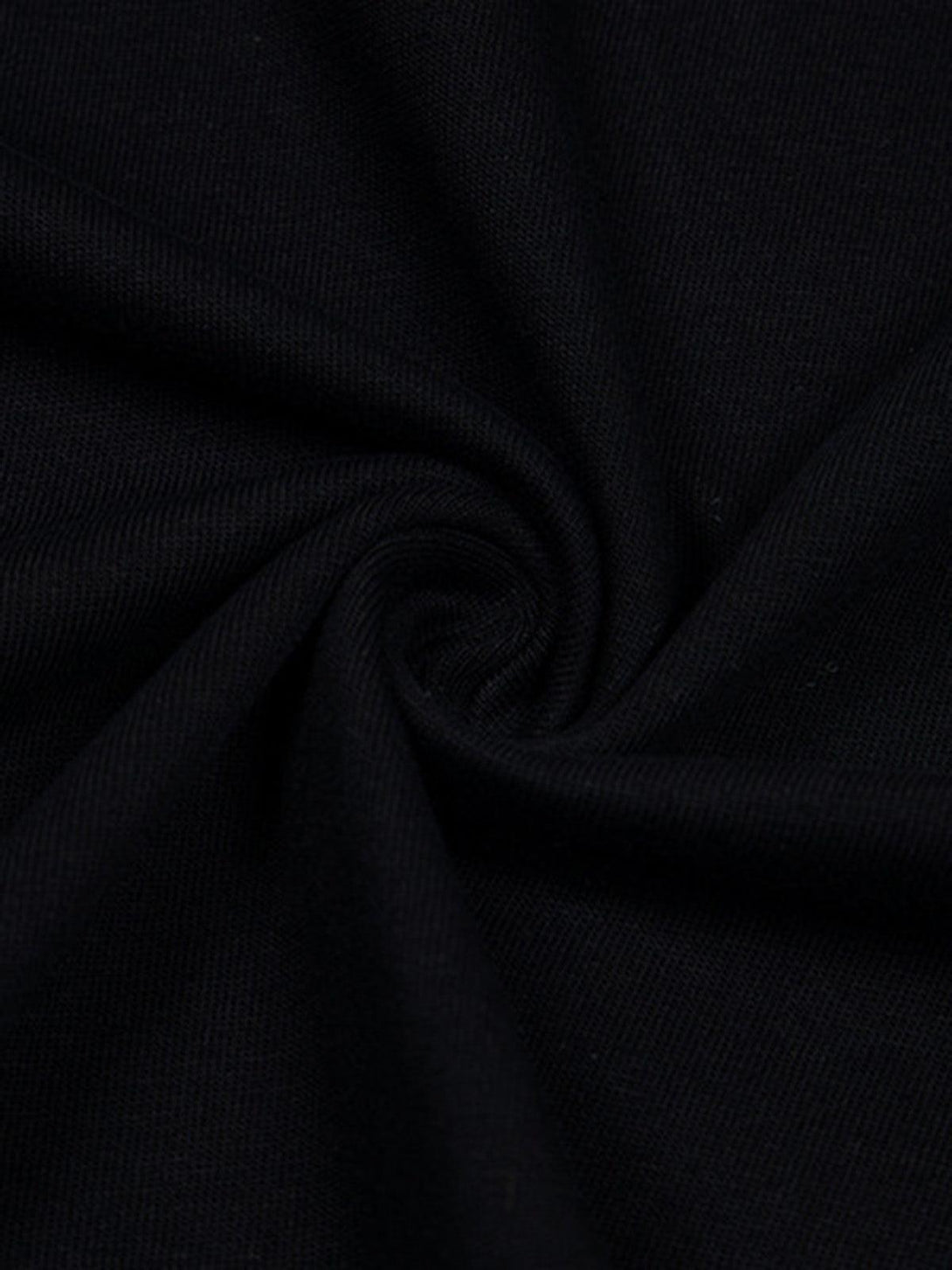 Intricate look at the rich black fabric texture of a TALISHKO t-shirt, capturing its quality.