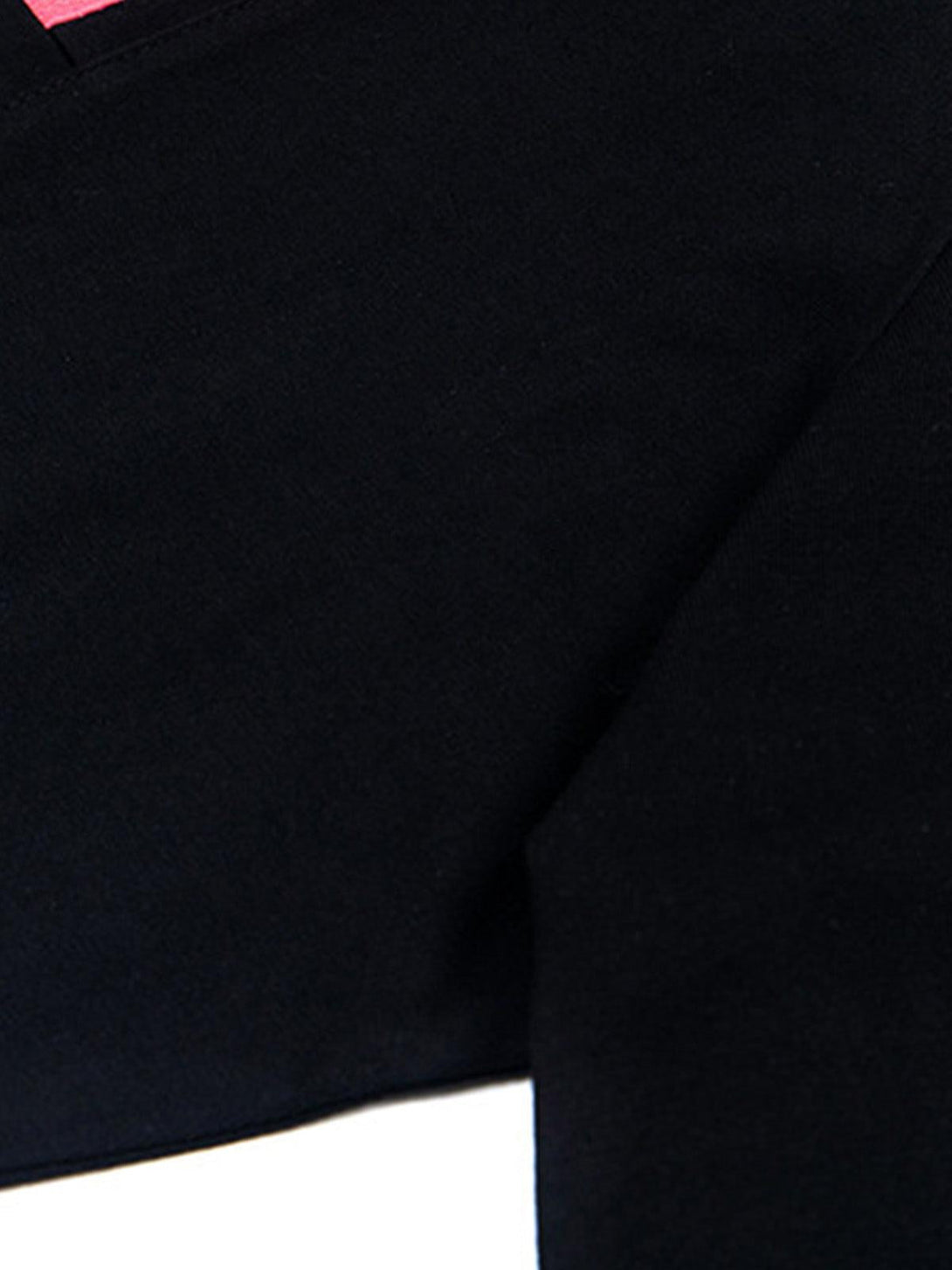 Zoomed-in texture of black fabric with pink accents by TALISHKO, highlighting its quality.