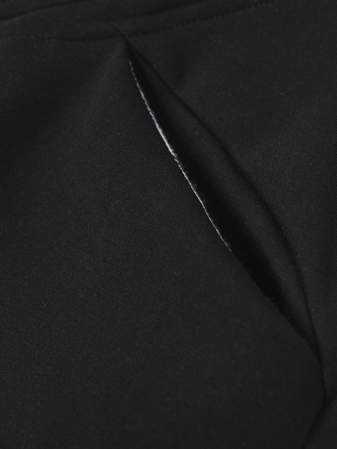 A tight crop highlighting the sleek pocket design of TALISHKO's hooded sweatshirt.