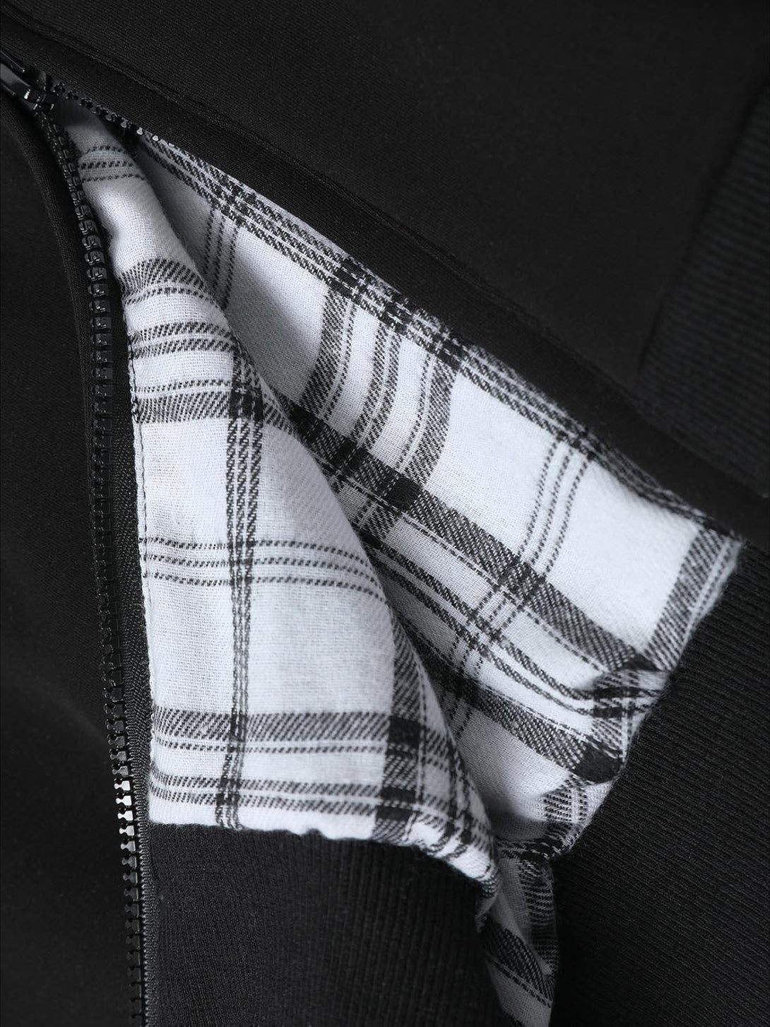 Plaid lining detail of TALISHKO's zip-up hooded sweatshirt, emphasizing stylish texture.