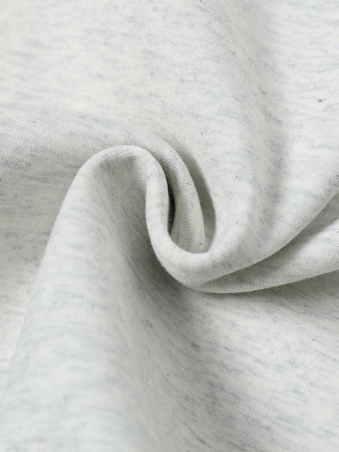 "Zoomed-in texture of TALISHKO's hooded sweatshirt, emphasizing the fabric's softness."