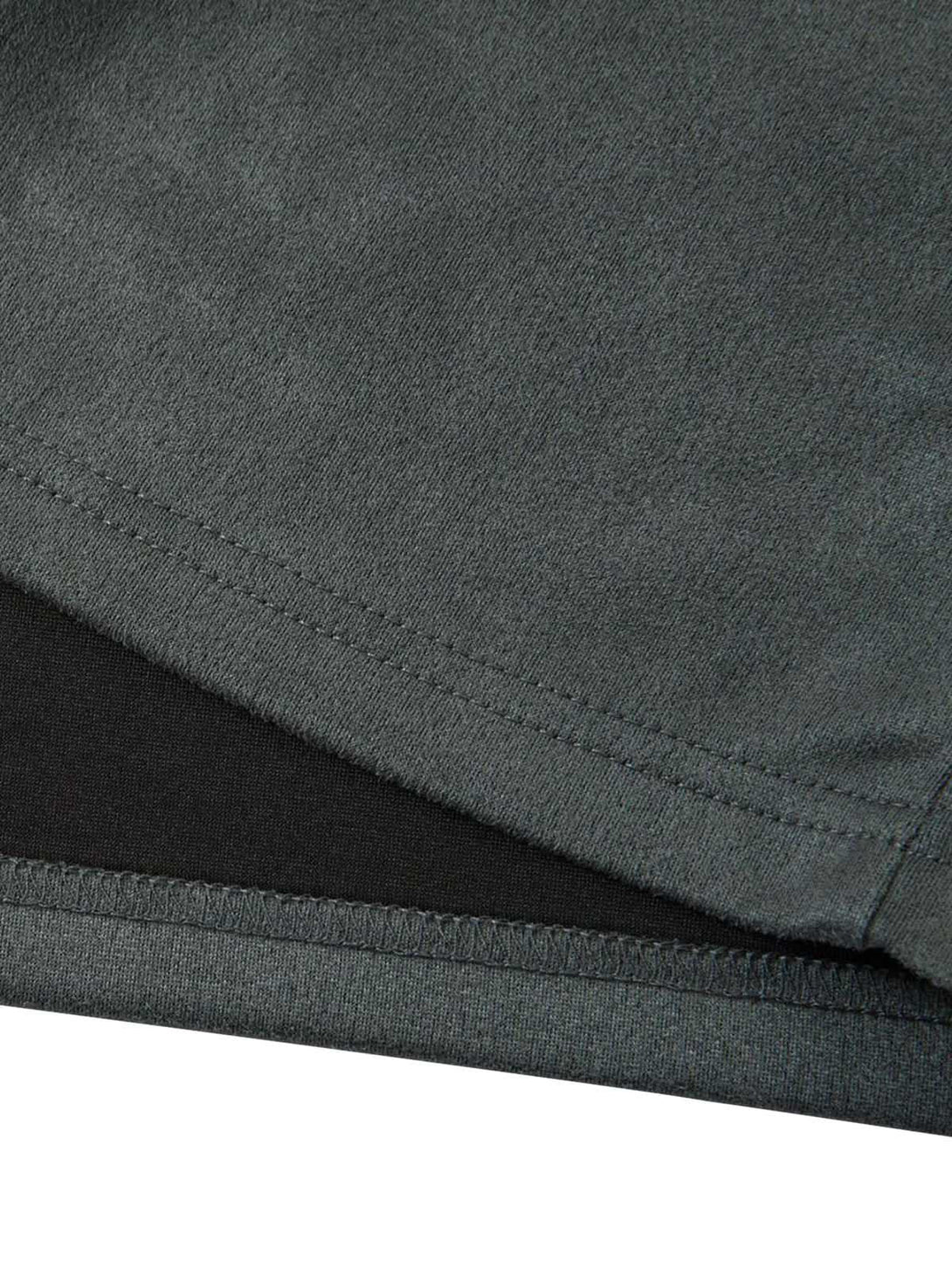 Intricate look at the stitching and texture of TALISHKO's retro suede T-shirt in dark gray.