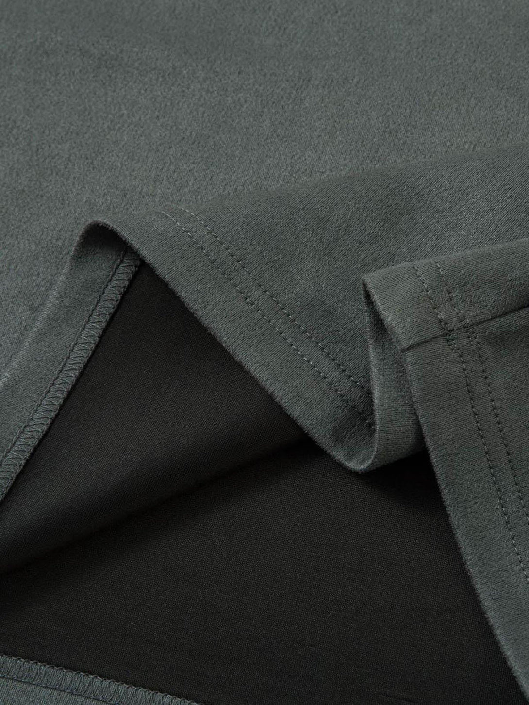 "Detailed fabric and stitching of TALISHKO's retro suede T-shirt, highlighting its quality finish."