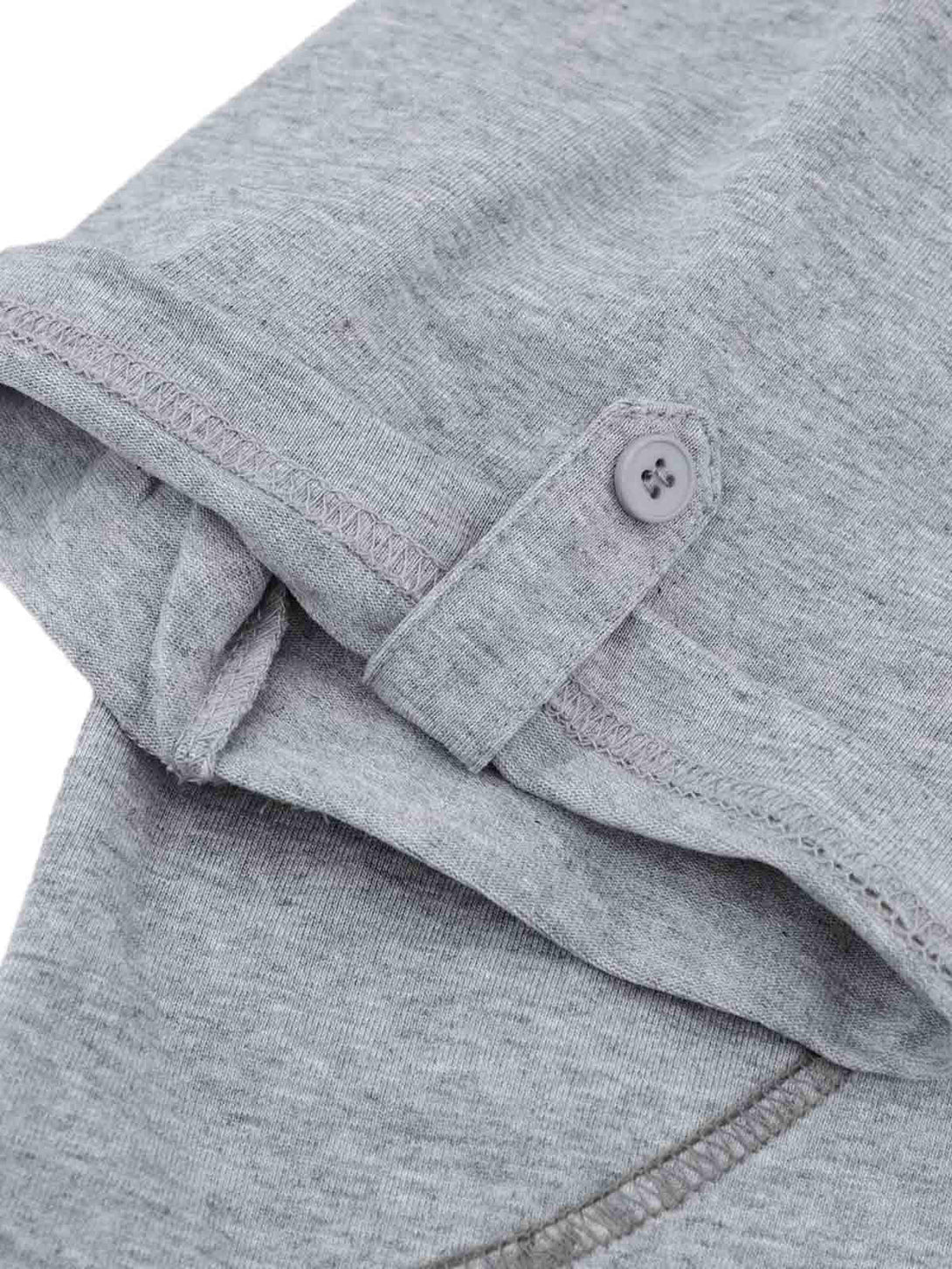 A close-up of the sleeve detail on a gray retro quilted T-shirt by TALISHKO, showcasing stitching.