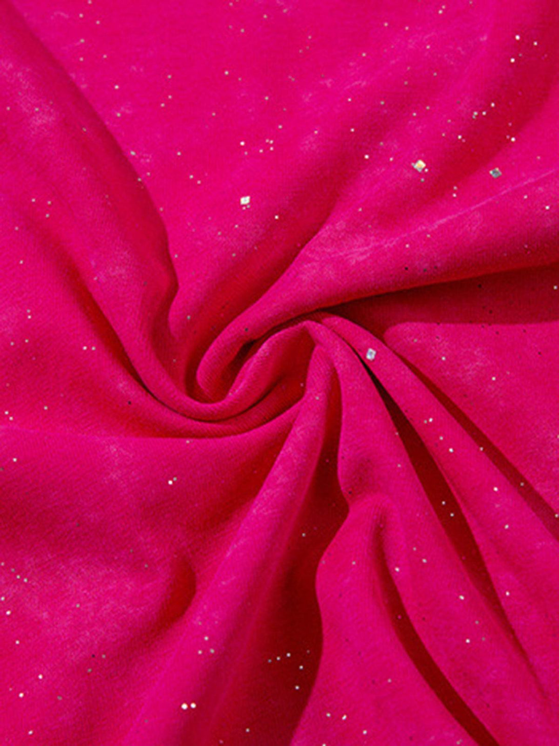 Zoomed-in texture of TALISHKO's vibrant fabric with glitter accents, highlighting its sparkle.