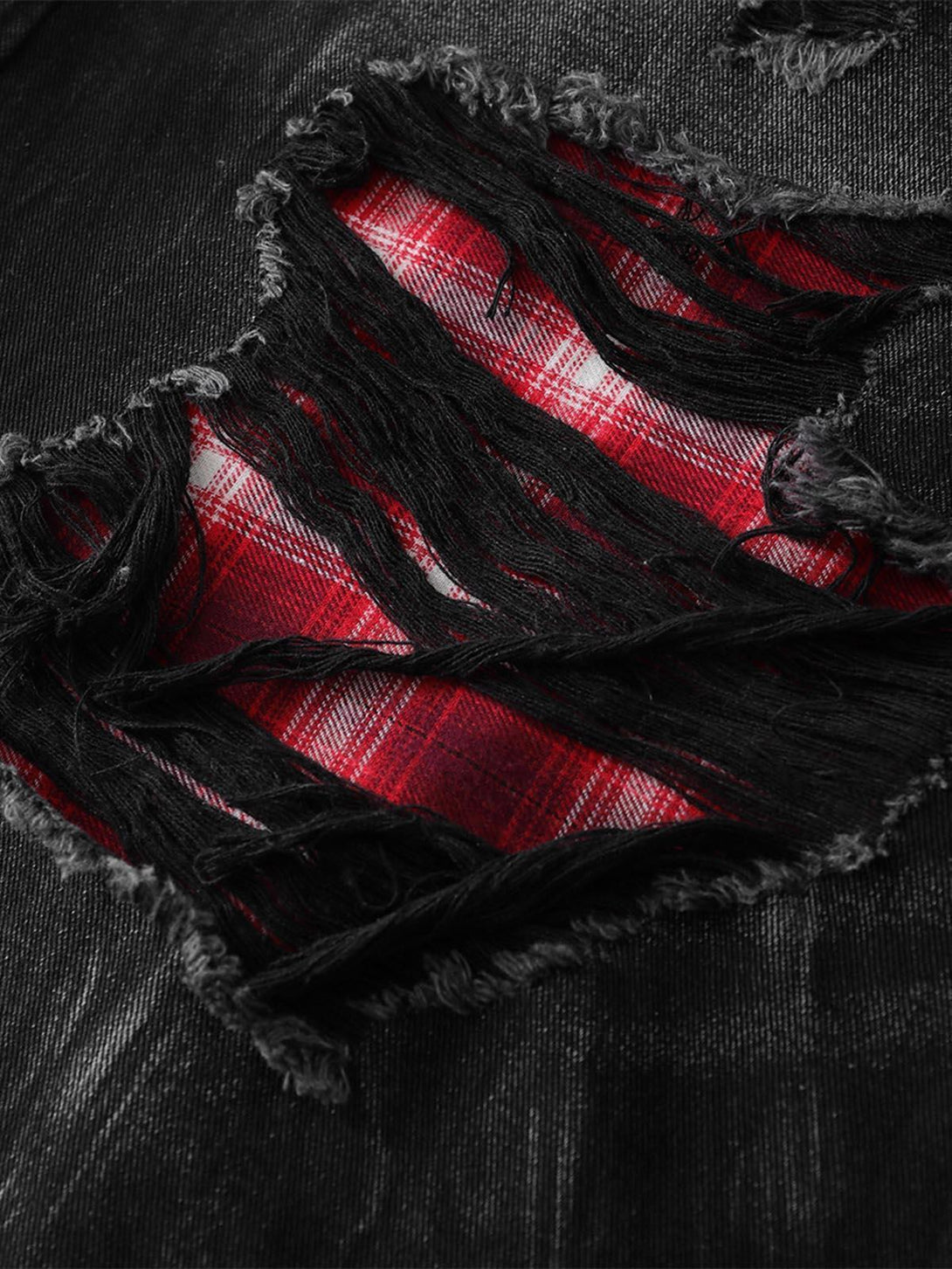 A detailed look at TALISHKO's retro plaid contrast on ripped denim shorts.