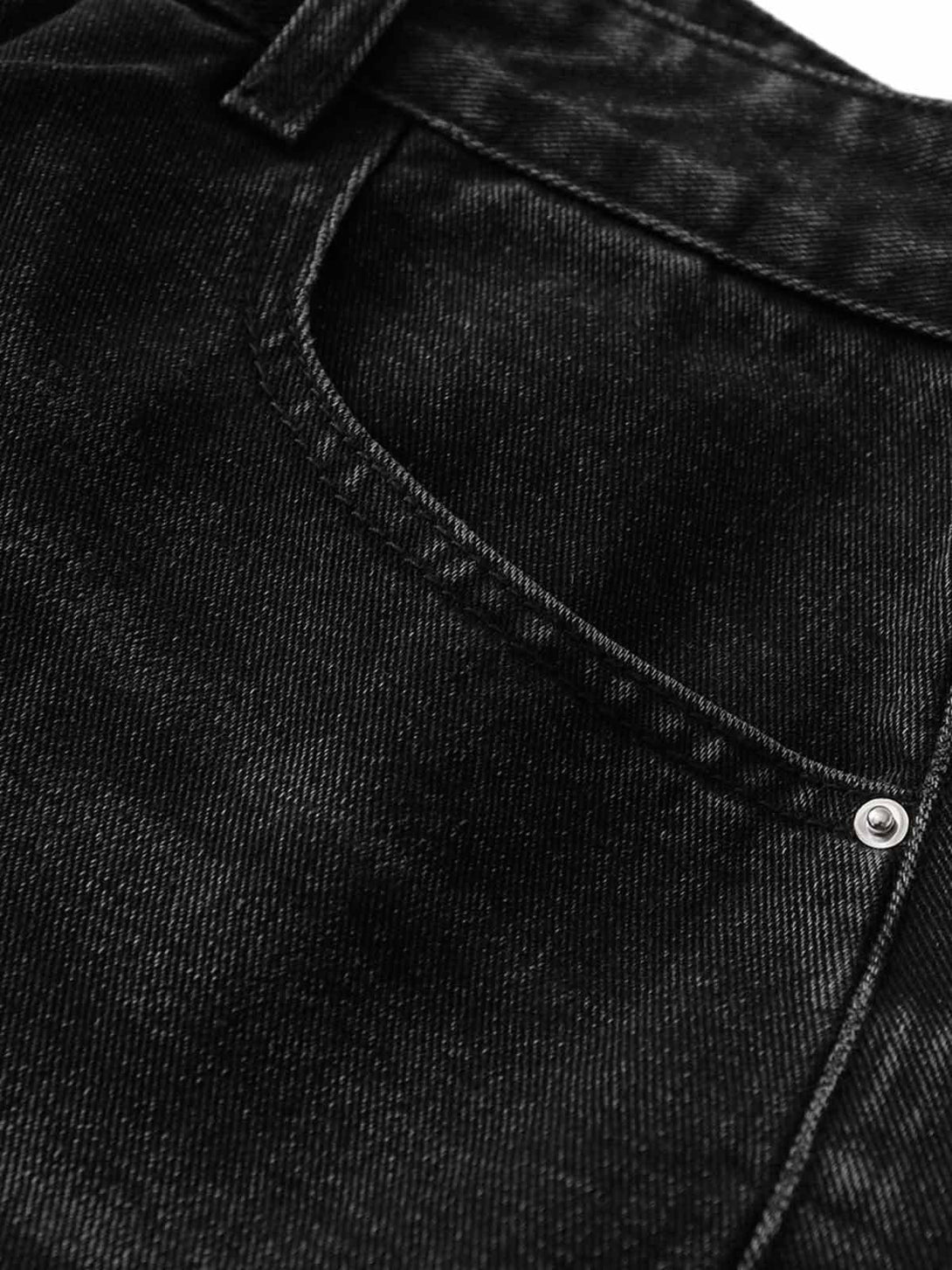Intricate look at TALISHKO's black denim shorts pocket, emphasizing texture and stitching.
