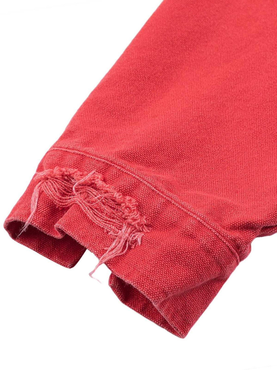 A detailed view of TALISHKO's retro work jacket cuff, showcasing distressed stitching.