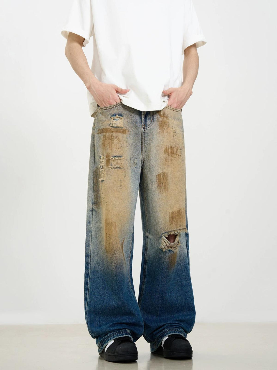 Wide-leg jeans with a distressed patina, worn by a model in a casual street style, by TALISHKO.