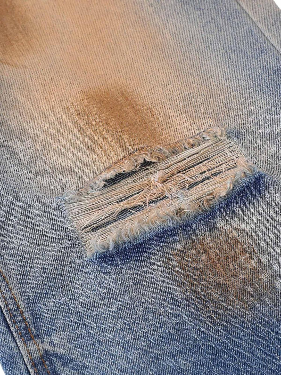 Detailed fabric and stitching of TALISHKO's retro street-style jeans with a washed patina.