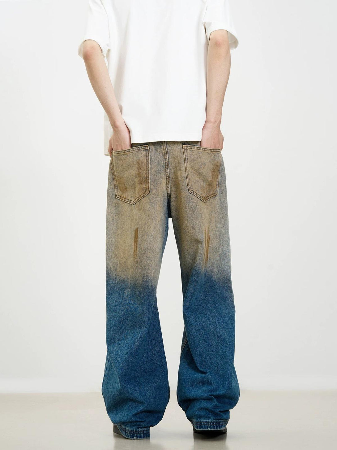 Back view of TALISHKO's wide-leg jeans featuring a retro washed patina and street style.