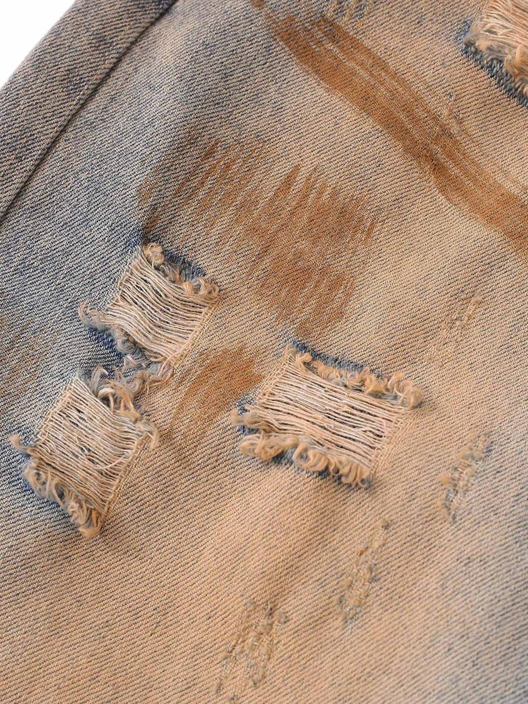 A detailed view of the distressed texture on TALISHKO's retro hip-hop jeans, highlighting the washed patina.