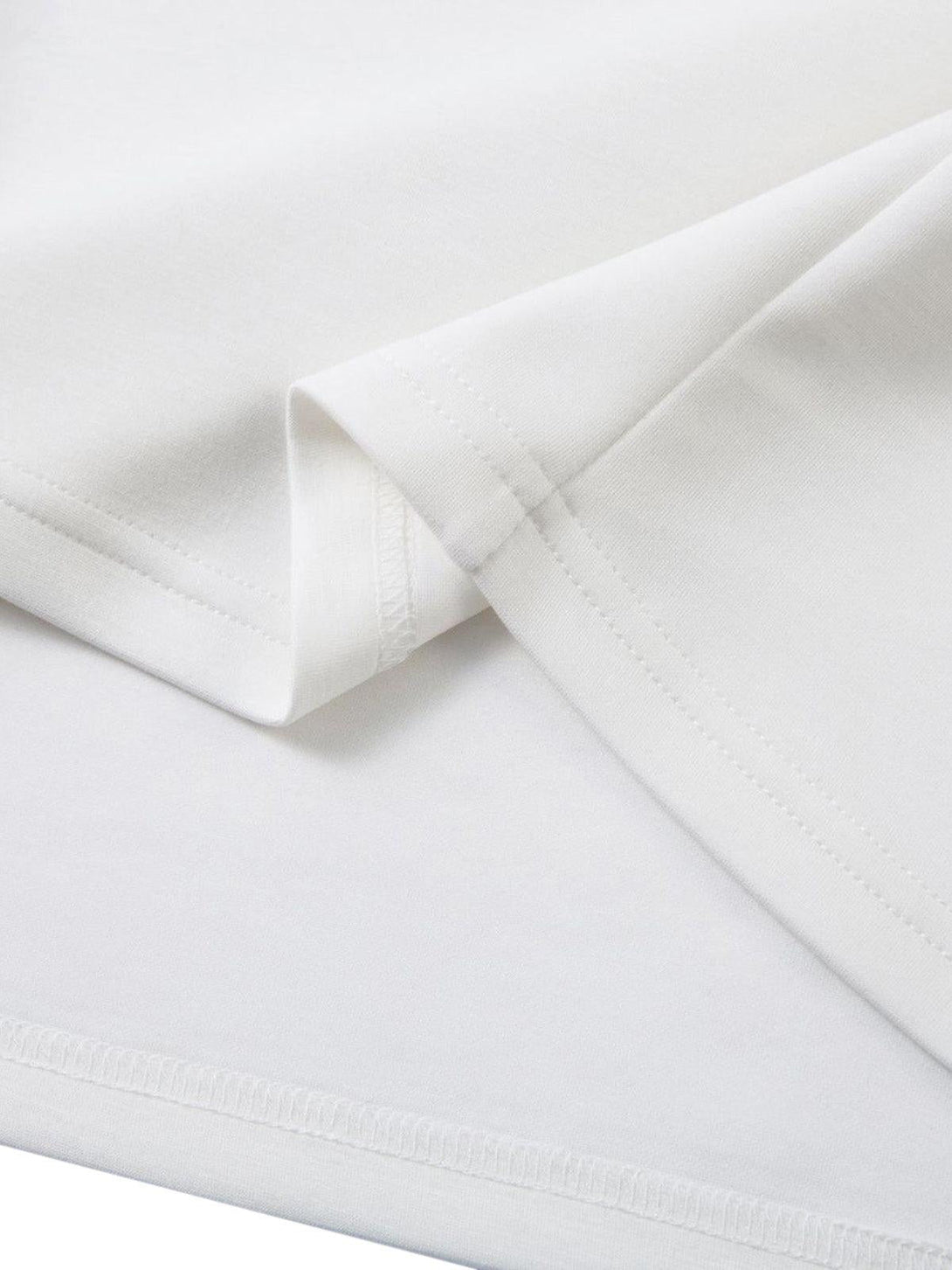 Detailed fabric and stitching of TALISHKO T-shirt, highlighting its smooth white material.