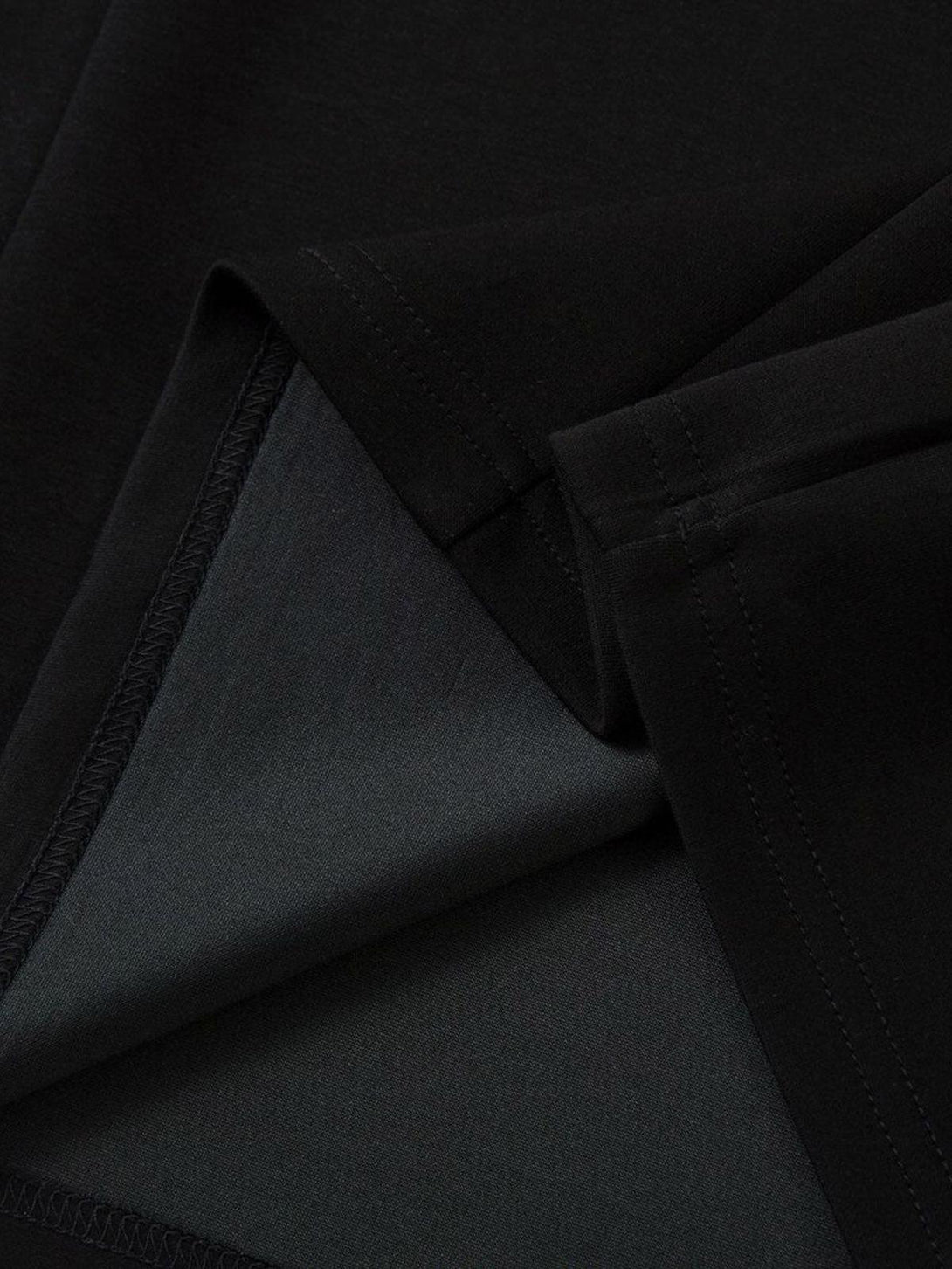 Detailed fabric and stitching in black, highlighting the unique style of TALISHKO's T-shirt.