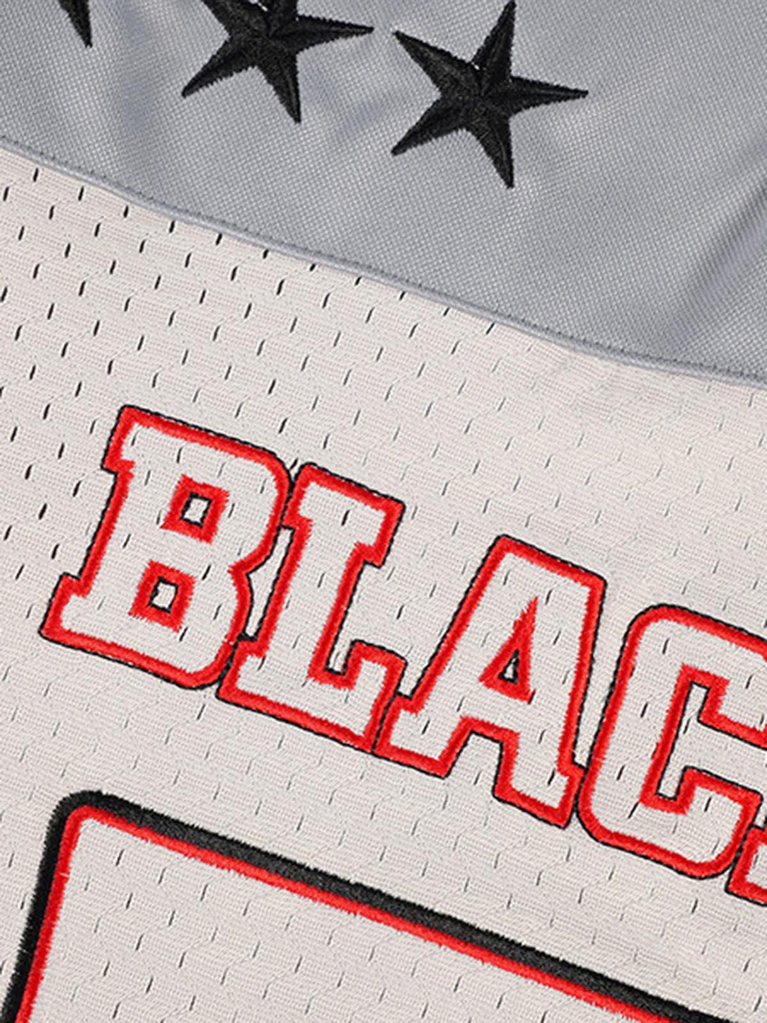 A detailed look at the TALISHKO retro sports jersey, featuring bold red lettering and star accents.