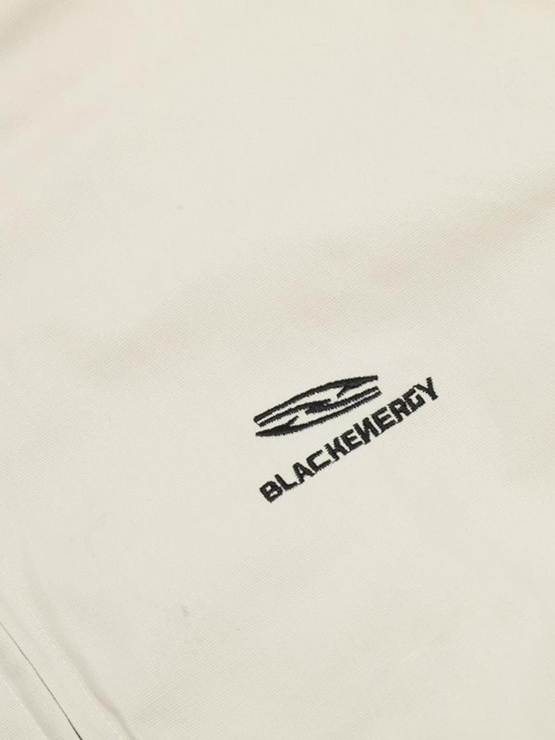 A detailed view of the TALISHKO logo on a retro stand collar casual jacket, highlighting branding.