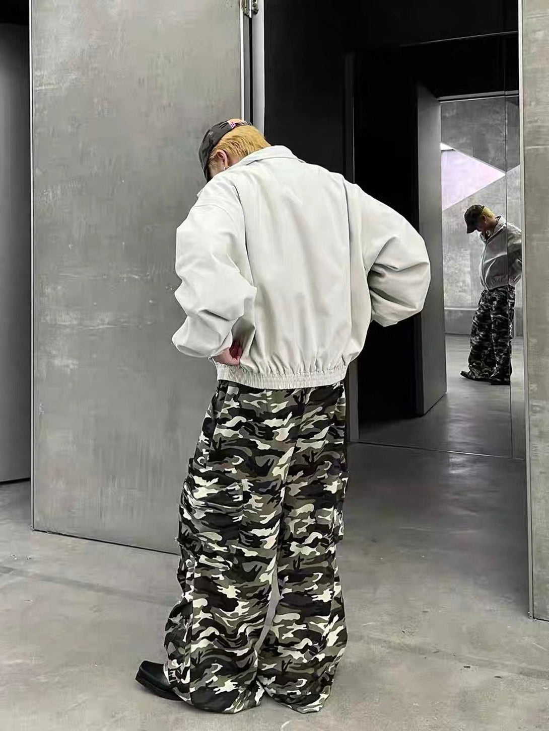 Back view of TALISHKO retro stand collar jacket paired with camo cargo pants in a modern setting.