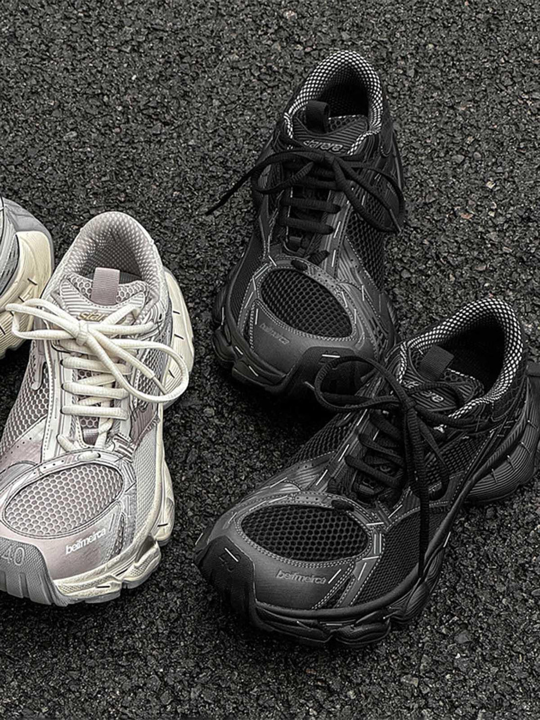 Retro chunky sneakers by TALISHKO in black and beige, highlighting textured details on asphalt.