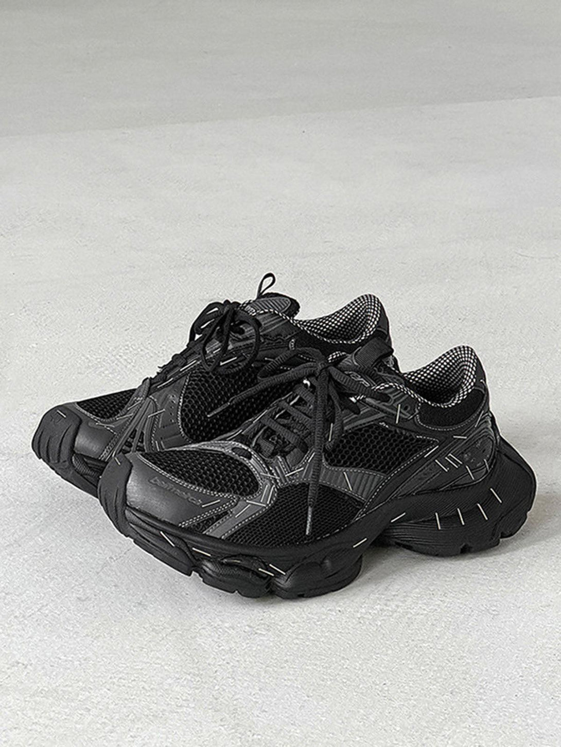 TALISHKO retro chunky sneakers in black, highlighting side details and mesh texture.