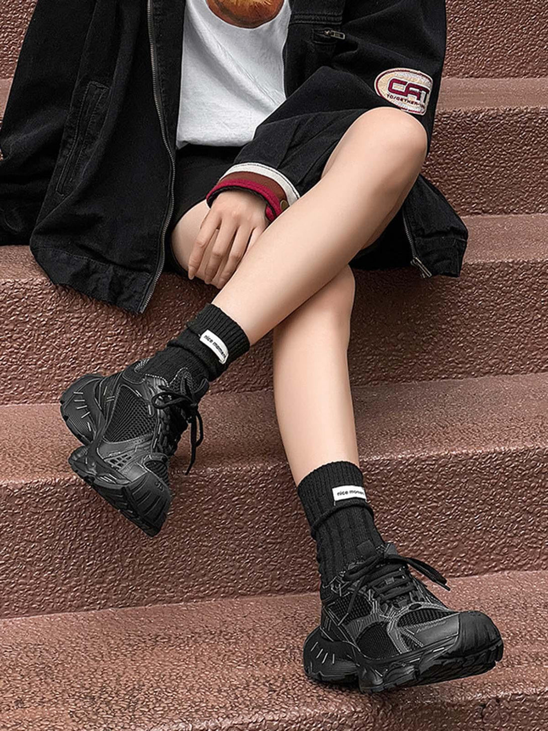 TALISHKO retro chunky sneakers in black, styled with a casual outfit and textured socks.