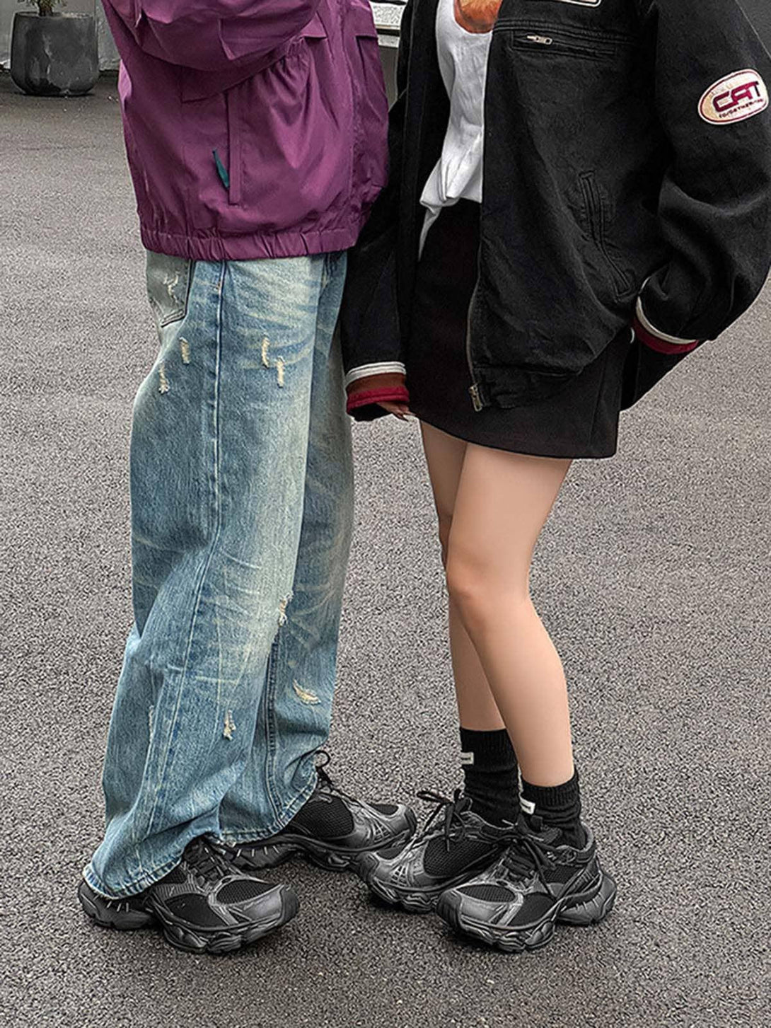 TALISHKO chunky sneakers in black, paired with casual streetwear, showcasing a trendy vibe.