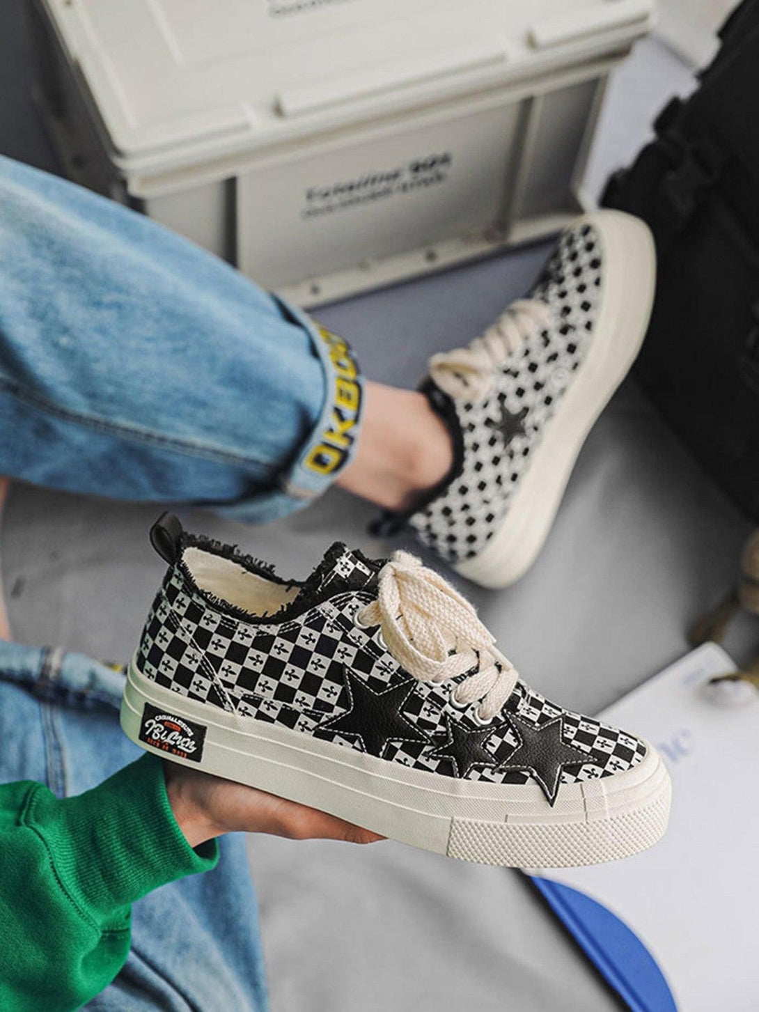 Retro star canvas shoes by TALISHKO with a bold checkered pattern and star detail, worn casually.