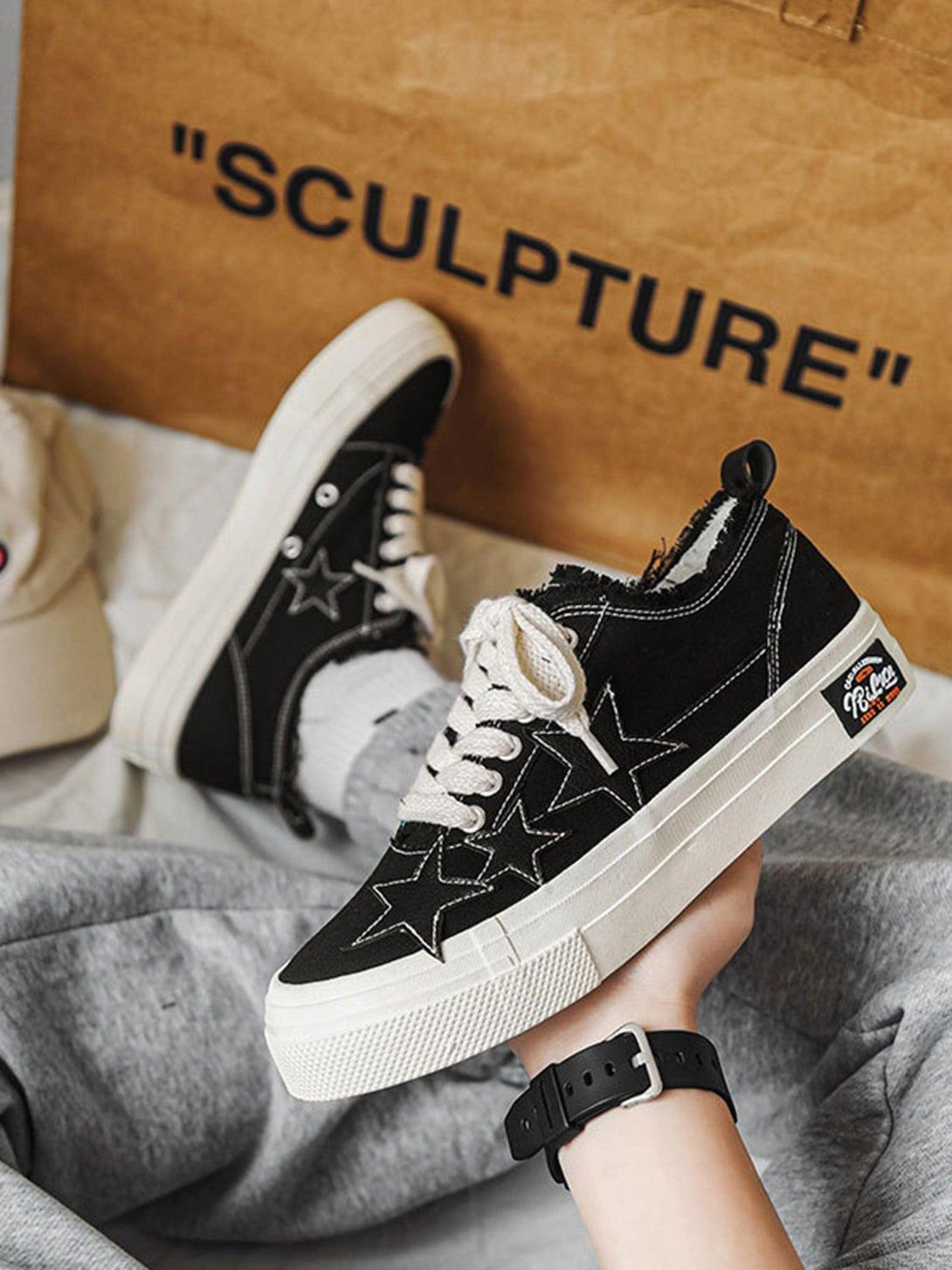 TALISHKO retro star canvas shoes in black with white laces, featuring a bold star design.