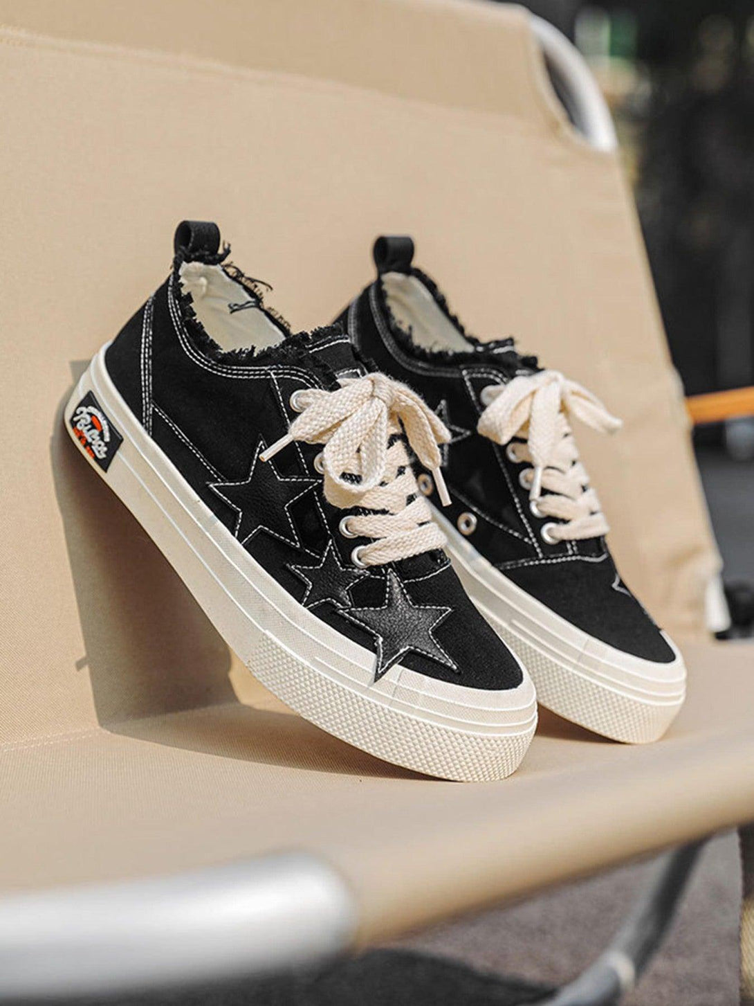TALISHKO retro star canvas shoes in black, featuring white laces and a stylish star design.
