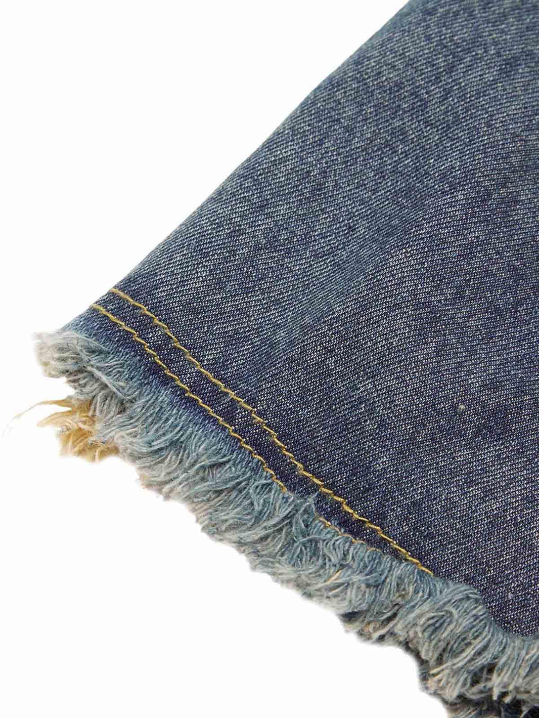 "Focusing on the frayed hem and retro stitching of TALISHKO denim shorts for a vintage touch."
