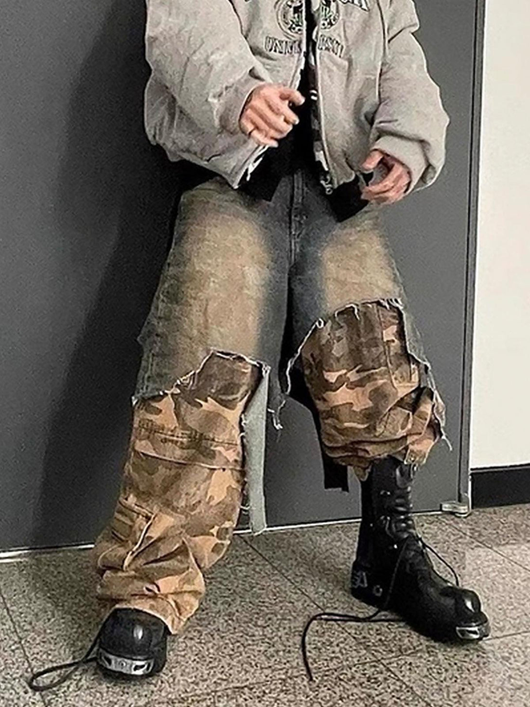 Model in TALISHKO's retro camouflage jeans with distressed details and unique styling.