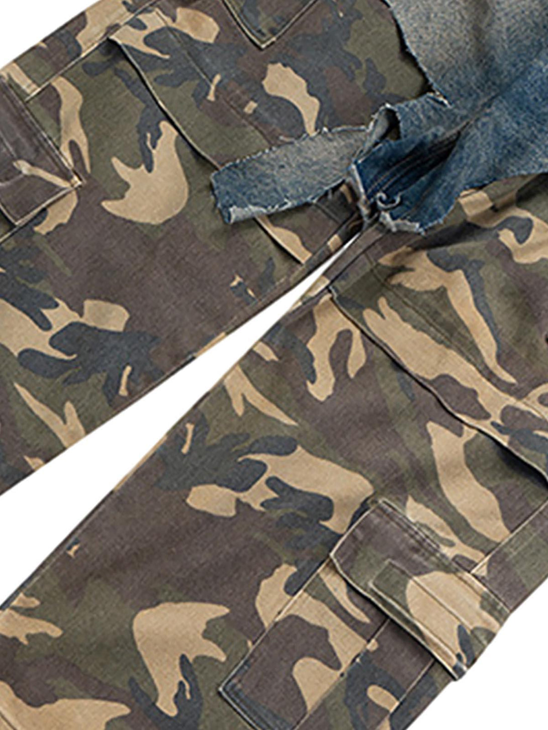 A detailed view of TALISHKO's camouflage jeans with a distressed denim overlay detail.