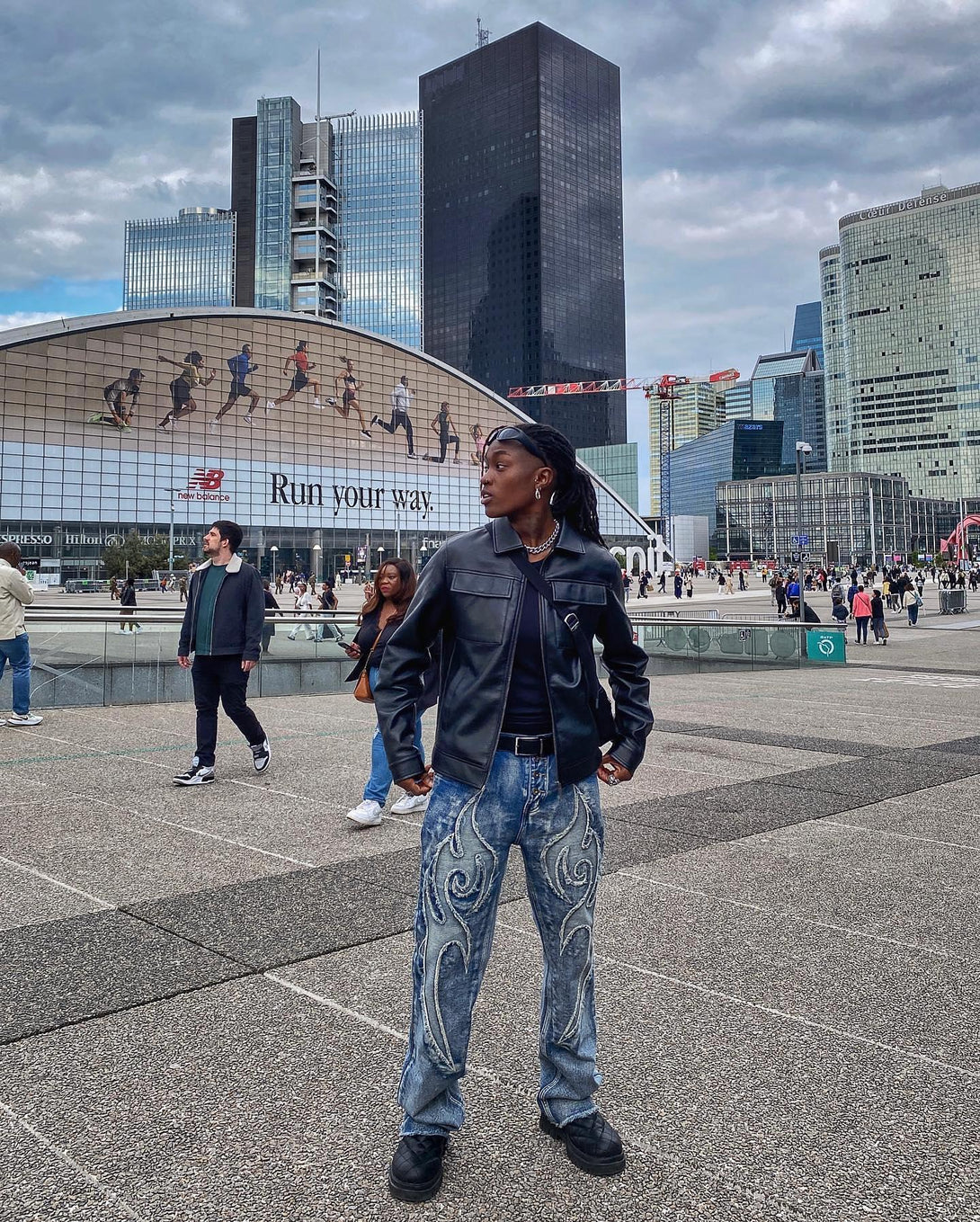 TALISHKO retro straight jeans with intricate swirl embroidery, worn with a sleek black jacket.