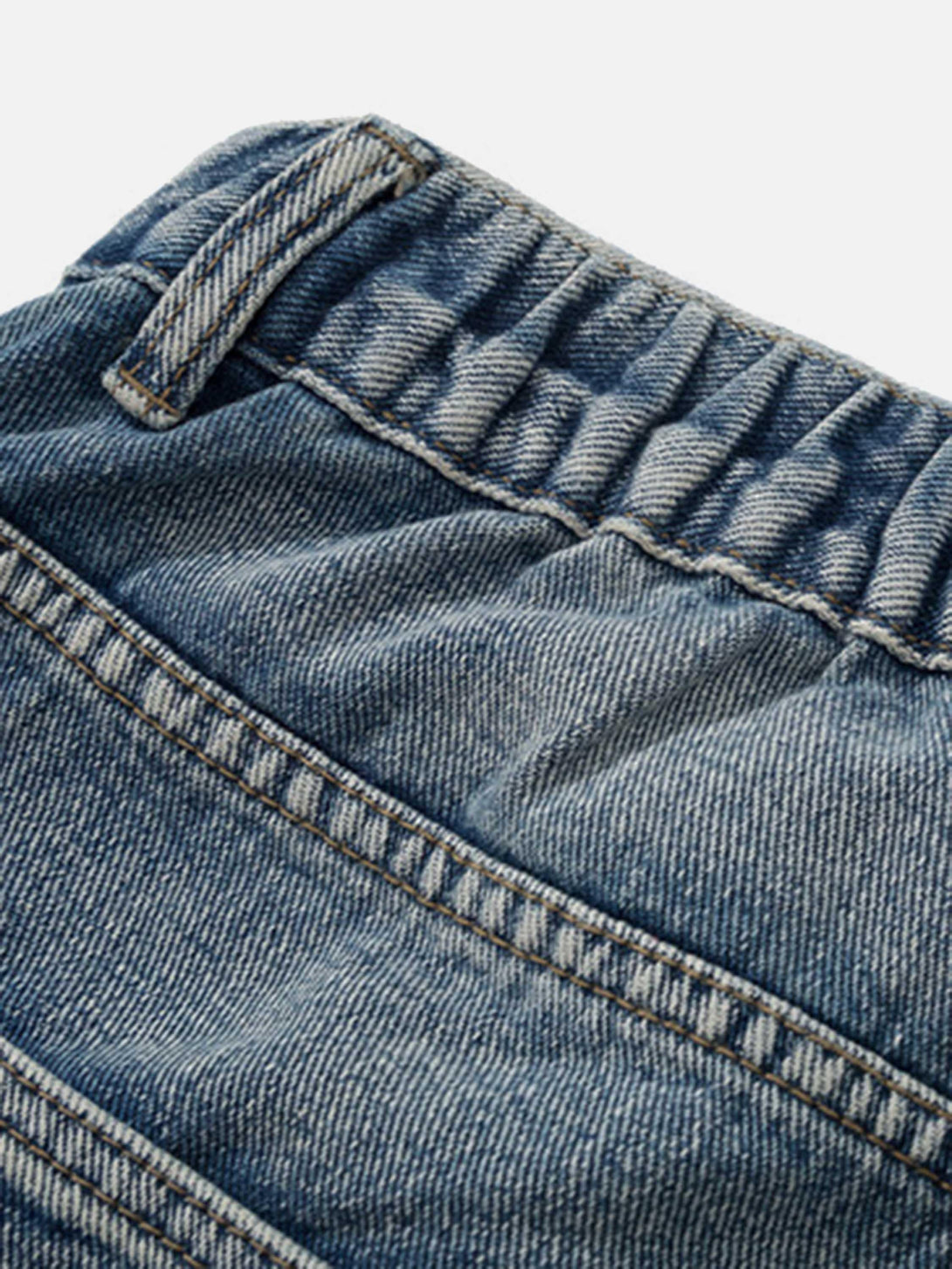 Intricate look at TALISHKO retro jeans showcasing elastic waistband and detailed stitching.