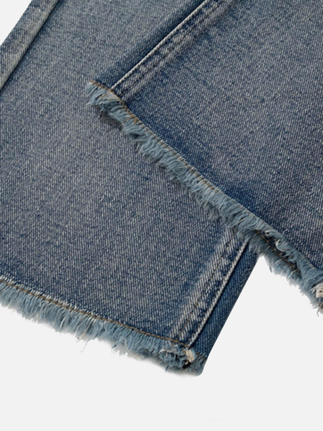Zoomed-in texture of TALISHKO retro straight casual jeans highlighting the raw hem detail.