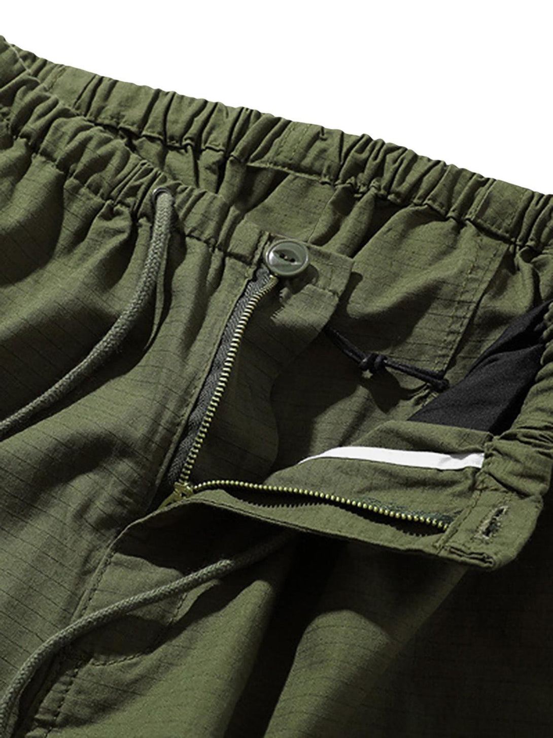 A detailed view of green retro casual pants by TALISHKO, highlighting the elastic waistband and zipper.