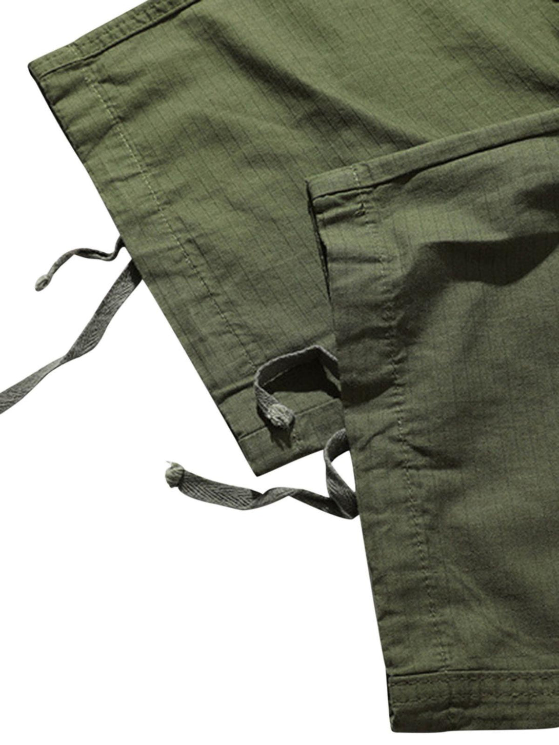 Detailed fabric and stitching of green retro casual pants by TALISHKO, highlighting drawstring ties.