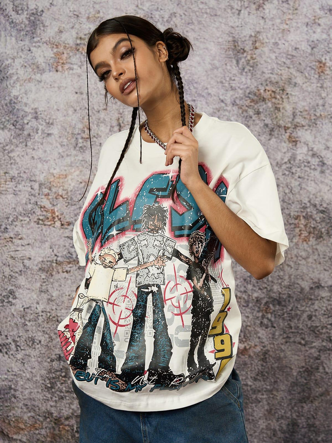 Model showcases a TALISHKO Retro Street graphic T-shirt with bold, colorful artwork.