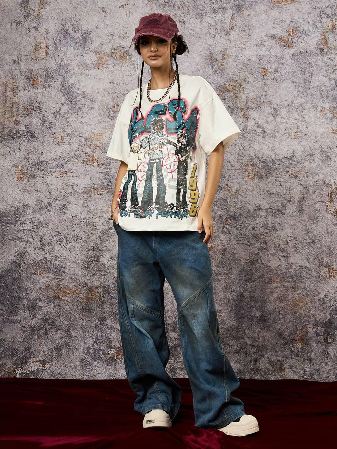 Model in TALISHKO Retro Street GLESA graphic T-shirt, paired with baggy jeans and a cap.