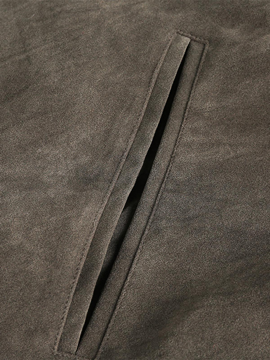 A detailed view of the TALISHKO retro suede motorcycle jacket pocket, showcasing its sleek design.