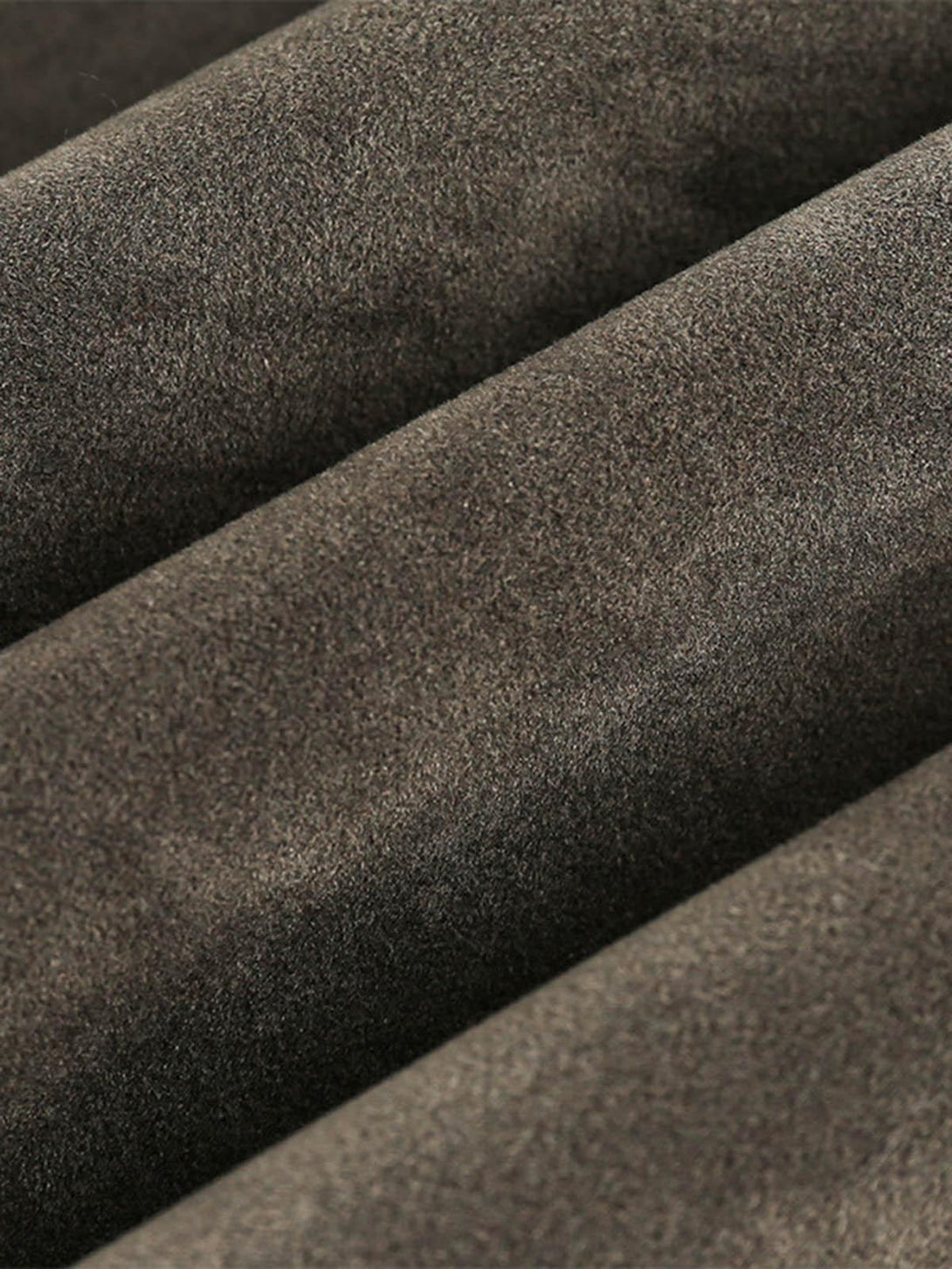 "Zoomed-in texture of the TALISHKO retro suede motorcycle jacket, highlighting its rich fabric."