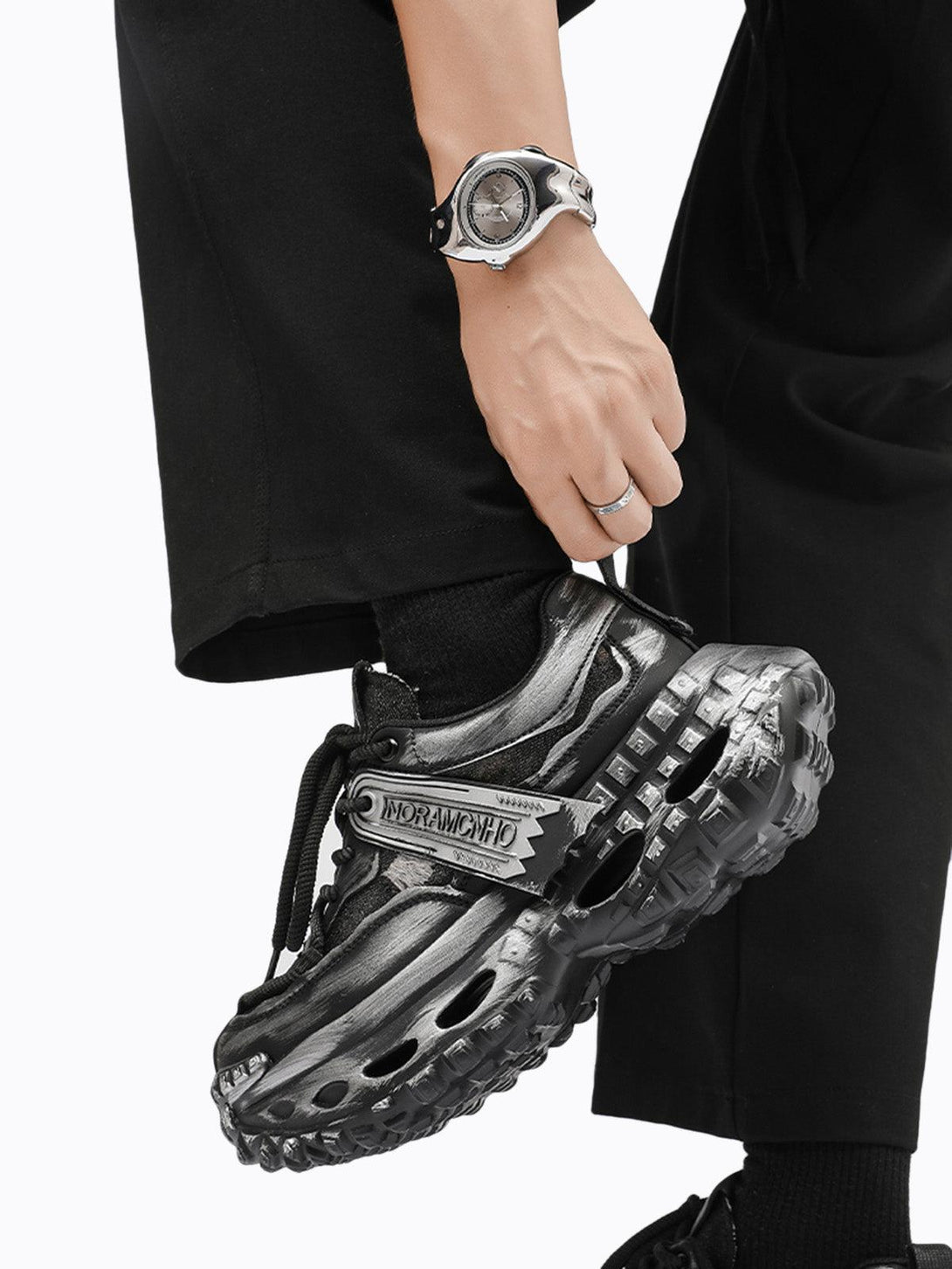 TALISHKO chunky sneakers with a unique tire sole, showcased in a dynamic streetwear style.
