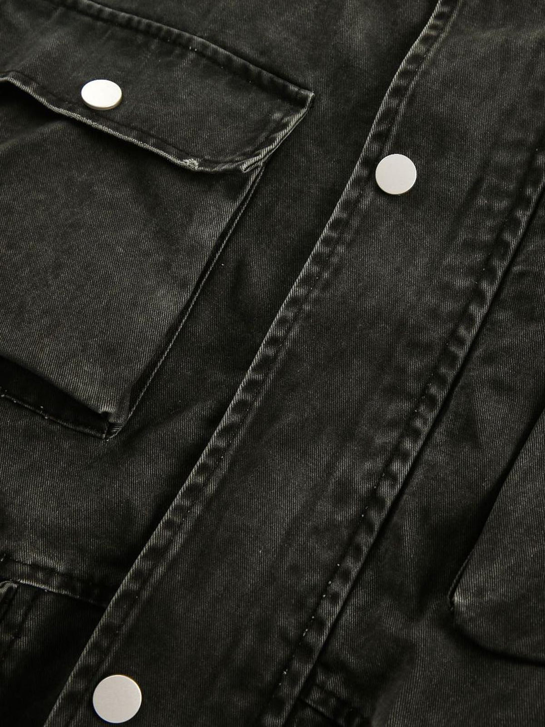 Intricate look at TALISHKO's retro washed work jacket, showcasing silver snap buttons.