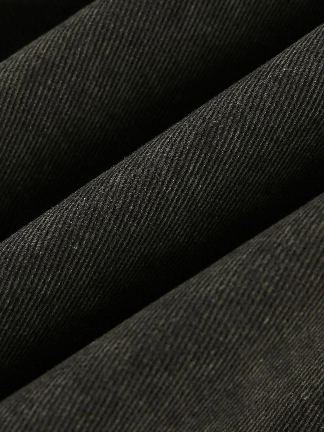 Zoomed-in texture of TALISHKO's retro washed work jacket, showcasing its intricate weave.