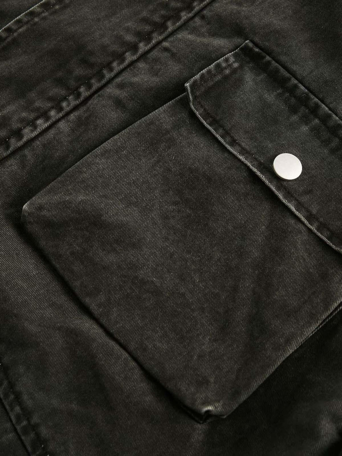 A tight crop highlighting TALISHKO's retro washed work jacket pocket with silver snap detail.