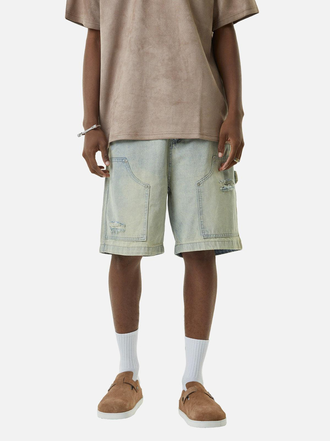 Model in TALISHKO retro washed hip-hop shorts, paired with brown shoes and white socks.