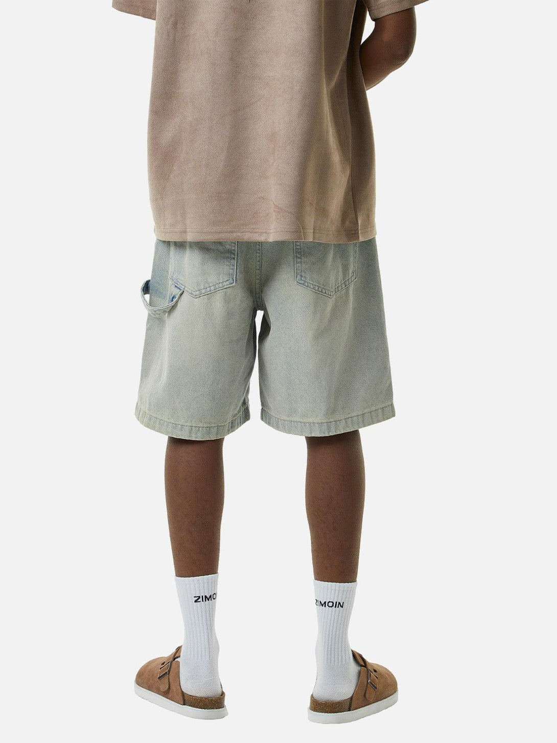Model in TALISHKO retro washed hip-hop shorts, highlighting a relaxed back view style.