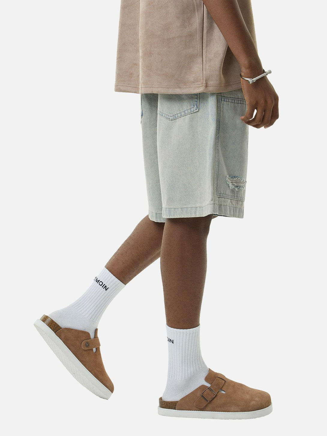 Model showcasing TALISHKO retro washed hip-hop shorts, paired with sandals and white socks.